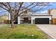 Charming two-story home featuring a two-car garage, front lawn, and inviting covered porch at 5716 S Lisbon Way, Centennial, CO 80015