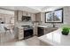 Modern kitchen features stainless steel appliances, sleek countertops, and ample cabinet space at 5716 S Lisbon Way, Centennial, CO 80015