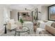 Bright living room showcases stylish furnishings, neutral tones, and seamless flow into the kitchen at 5716 S Lisbon Way, Centennial, CO 80015
