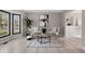 Inviting living room with a cozy seating area, light wood floors, and an abundance of natural light at 5716 S Lisbon Way, Centennial, CO 80015