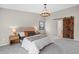 Serene main bedroom featuring a sliding barn door to the bathroom, plush carpet, and stylish furnishings at 5716 S Lisbon Way, Centennial, CO 80015