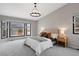 Elegant main bedroom with a large window, modern lighting, and calming neutral tones at 5716 S Lisbon Way, Centennial, CO 80015