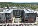 Aerial view of a modern apartment complex featuring a central courtyard with a pool and green spaces at 20 Wilcox St # 517, Castle Rock, CO 80104
