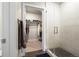 Bright, modern bathroom with glass shower stall next to a walk-in closet with shelves and hanging clothes at 20 Wilcox St # 517, Castle Rock, CO 80104