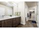 Modern bathroom featuring double sinks, wood cabinets, and a walk-in closet at 20 Wilcox St # 517, Castle Rock, CO 80104