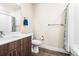 Cozy bathroom featuring wood cabinets, a white countertop, a toilet and shower with modern accents at 20 Wilcox St # 517, Castle Rock, CO 80104