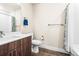 Bright bathroom featuring a dark wood vanity with white countertop, a toilet, and a combined shower-tub at 20 Wilcox St # 517, Castle Rock, CO 80104