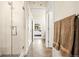 Modern bathroom with glass-enclosed shower, tiled walls, and a hallway view with a closet and bath towels at 20 Wilcox St # 517, Castle Rock, CO 80104