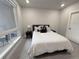 Comfortable bedroom featuring a bed with luxurious white linens, and a well-lit room with neutral accents at 20 Wilcox St # 517, Castle Rock, CO 80104