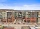 Modern apartment complex boasting a large courtyard and street-level retail spaces, set against a mountain backdrop at 20 Wilcox St # 517, Castle Rock, CO 80104