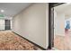 Hallway leading into a light-filled condo with patterned carpet at 20 Wilcox St # 517, Castle Rock, CO 80104