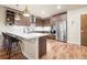 Modern kitchen featuring stainless steel appliances, wood cabinets, and an island with barstool seating at 20 Wilcox St # 517, Castle Rock, CO 80104
