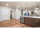 Modern kitchen featuring an island with a white countertop and stainless steel appliances and wood floors at 20 Wilcox St # 517, Castle Rock, CO 80104