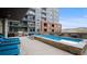 Rooftop pool area offering a relaxing lounge space with chairs, a grill, and city views at 20 Wilcox St # 517, Castle Rock, CO 80104