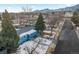 Aerial view of a charming blue house showcasing its well-maintained exterior and neighborhood surroundings under a bright sky at 4640 Macky Way, Boulder, CO 80305