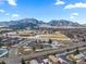 Expansive aerial view featuring neighborhood homes, school and mountains on the horizon at 4640 Macky Way, Boulder, CO 80305