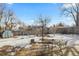 This backyard features a patio set and shed, surrounded by winter's touch of snow and bare trees at 4640 Macky Way, Boulder, CO 80305