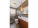 Stylish bathroom featuring slate tile walls, a modern vanity, and a glass-enclosed shower at 4640 Macky Way, Boulder, CO 80305