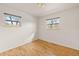 Clean, simple bedroom with hardwood flooring and natural light from two well-placed windows at 4640 Macky Way, Boulder, CO 80305