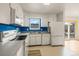 Functional kitchen featuring white appliances, blue backsplash and an adjacent dining area at 4640 Macky Way, Boulder, CO 80305