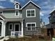 Charming two-story home featuring a covered porch, stone accents, and freshly landscaped front yard at 15238 Detroit St, Thornton, CO 80602