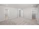 Spacious bedroom with plush carpet, three doorways, and neutral walls at 7310 Watercress Dr, Littleton, CO 80125