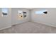 Bedroom with neutral carpet, baseboards, and several windows at 7310 Watercress Dr, Littleton, CO 80125