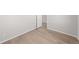 Neutral bedroom featuring wood-look flooring, white trim and walls, and a modern door at 7310 Watercress Dr, Littleton, CO 80125