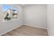 Bright bedroom with wood floors and large window, offering ample natural light and neighborhood views at 7310 Watercress Dr, Littleton, CO 80125
