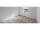 Bright bedroom with plush carpet, large window and neutral color scheme at 7310 Watercress Dr, Littleton, CO 80125