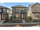 Modern two-story home featuring gray siding, large windows, and a well-manicured front yard at 7310 Watercress Dr, Littleton, CO 80125