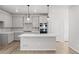 Well-lit kitchen featuring a spacious island, stainless steel appliances, and ample counter space at 7310 Watercress Dr, Littleton, CO 80125