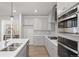 Contemporary kitchen with stainless steel appliances, gray cabinetry, and a functional center island at 7310 Watercress Dr, Littleton, CO 80125