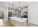 Modern kitchen with a large center island, stainless steel appliances, and sleek gray cabinetry at 7310 Watercress Dr, Littleton, CO 80125