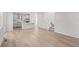 Open-concept living space showcasing wood-look flooring, modern kitchen, and staircase at 7310 Watercress Dr, Littleton, CO 80125