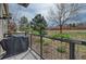Apartment balcony overlooking mature landscaping with flower boxes, trees, and a grill covered by a tarp at 5677 S Park Pl # B110, Greenwood Village, CO 80111