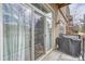 Balcony with sliding glass doors and a grill covered by a tarp, providing space for outdoor cooking at 5677 S Park Pl # B110, Greenwood Village, CO 80111
