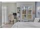Cozy bedroom featuring a desk, bookshelf, window, and comfortable bed providing a peaceful retreat at 5677 S Park Pl # B110, Greenwood Village, CO 80111