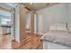 This bedroom includes hardwood floors, and a mirrored wardrobe adding style and function at 5677 S Park Pl # B110, Greenwood Village, CO 80111