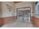 Apartment building entrance featuring secured iron gates, brick, and tile at 5677 S Park Pl # B110, Greenwood Village, CO 80111