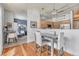 Well-lit dining area features a wooden table, upholstered chairs, and hanging pendant lights adjacent to the kitchen at 5677 S Park Pl # B110, Greenwood Village, CO 80111