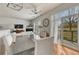 Bright dining room with wood floors, an outdoor patio, neutral walls, and a modern ceiling fan at 5677 S Park Pl # B110, Greenwood Village, CO 80111