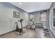 Home gym featuring exercise bike, elliptical machine, free weights and work bench at 5677 S Park Pl # B110, Greenwood Village, CO 80111