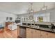 Open-concept kitchen overlooking the living room with stainless steel appliances and hardwood floors at 5677 S Park Pl # B110, Greenwood Village, CO 80111