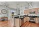 Open kitchen with granite countertops, stainless steel appliances, pendant lighting, and hardwood floors at 5677 S Park Pl # B110, Greenwood Village, CO 80111
