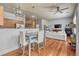 Open-concept living space with dining area, modern lighting, ceiling fan, wood floors, and a comfortable sofa at 5677 S Park Pl # B110, Greenwood Village, CO 80111