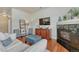 Inviting living room featuring a fireplace, TV, bookcase, and comfortable furniture at 5677 S Park Pl # B110, Greenwood Village, CO 80111