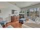 Cozy living room features a fireplace, built-in cabinet, and oversized window providing abundant natural light at 5677 S Park Pl # B110, Greenwood Village, CO 80111