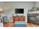 Comfortable living area with fireplace, television, and reading chair at 5677 S Park Pl # B110, Greenwood Village, CO 80111