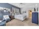 Comfortable main bedroom featuring a sitting area, natural light, and a private bathroom at 5677 S Park Pl # B110, Greenwood Village, CO 80111